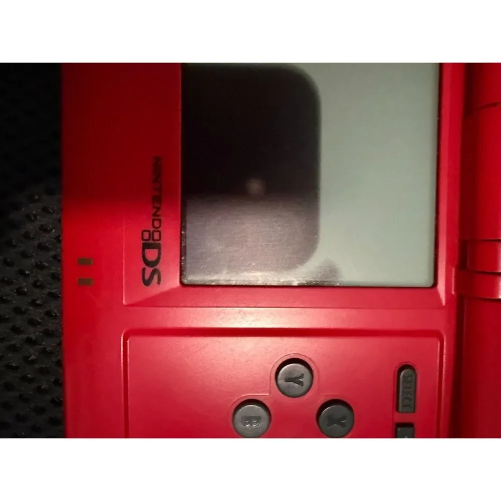Red nintendo DS with charger and 3 games gently used